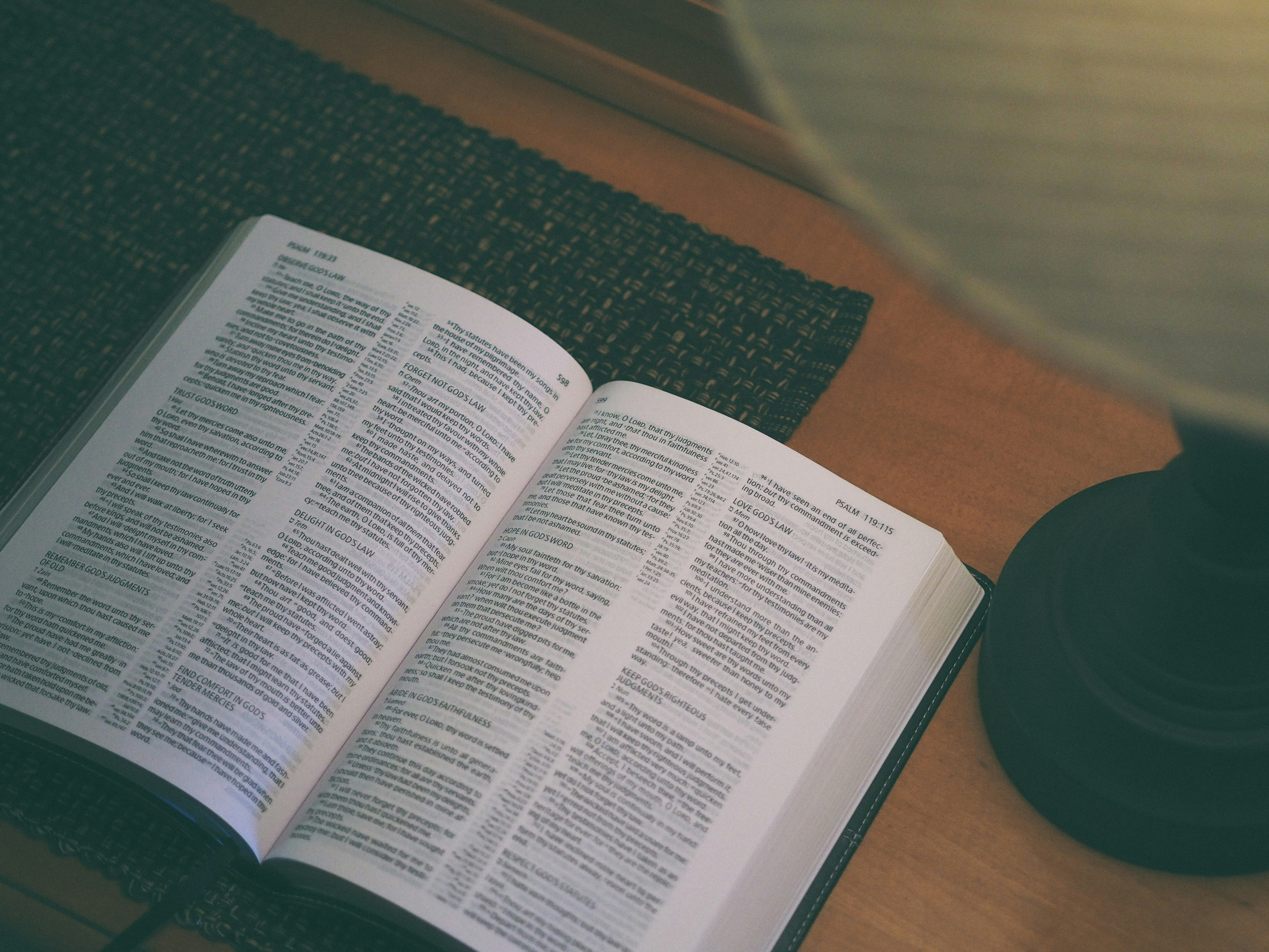 white book beside black table lamp